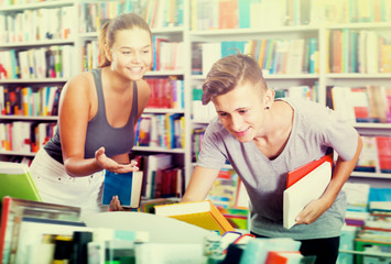 Fototapeta premium Portrait of girl and boy taking books