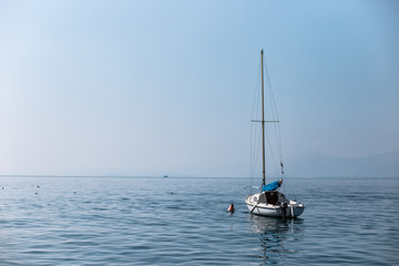 Lonely boat in the lake - Lake Garda (Italy)