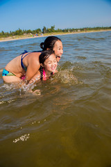 Mother and Daughter play at the beach