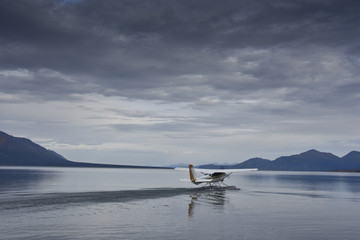 single seaplane starting on a lake in alaska