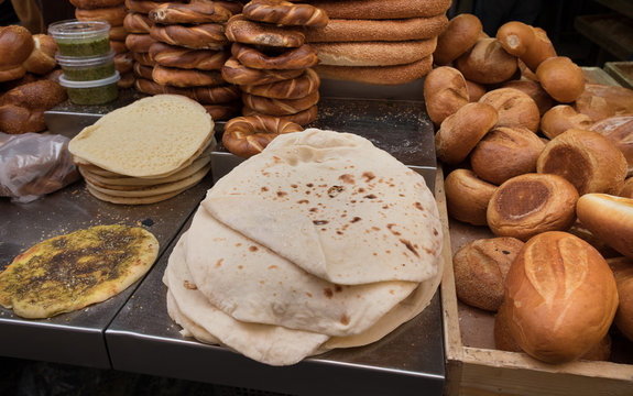 Fresh tradition iraqian bread and group of baked goods for sale at Mahane Yehuda Market, popular marketplace in Jerusalem, Israel