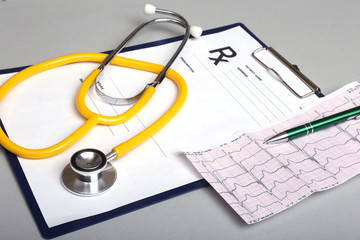 RX prescription and a stethoscope on white background