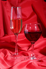 Two Glass of red, white wine on red background