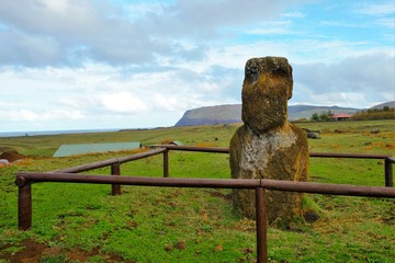 Shot of a Moai statue behind a wooden fence in Easter Island, Rapa Nui, Chile, South America
