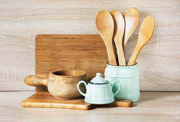 Turquoise and wooden vintage crockery, tableware, dishware utensils and stuff on wooden table-top. Kitchen still life as background for design. Image with copy space.