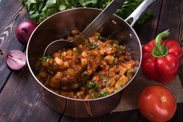  Bean sauce in a saucepan on a wooden background