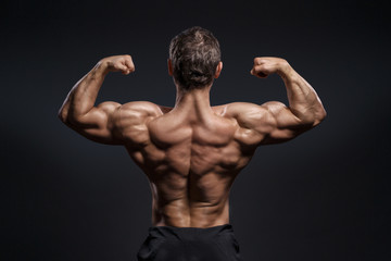 Fototapeta na wymiar Handsome power bodybuilder showing his back