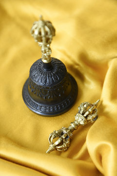 Small metal scepter called dorje or vajra and Tibetan prayer bell for meditation