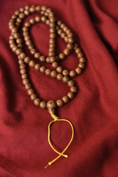 Buddhist prayer mala and red shawl