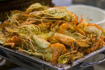grilled shrimps on silver tray in the market