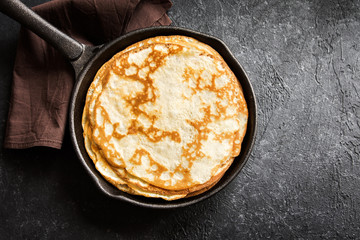 crepes in cast iron pan - obrazy, fototapety, plakaty
