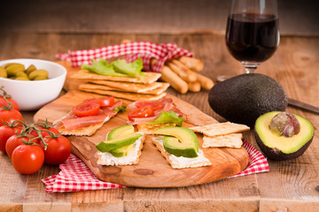 Crackers with ham and avocado. 