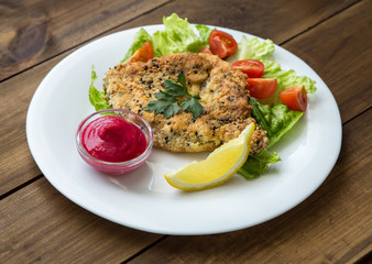 Homemade Breaded Schnitzel with salad and berry sauce