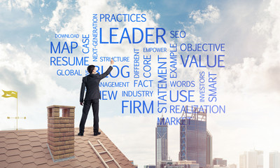 Young businessman standing on house roof and writing leadership 