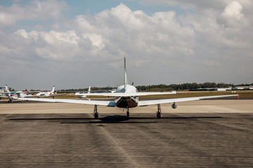 Private small single piston aircraft on airport runway - obrazy, fototapety, plakaty