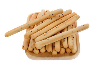 Black sesame biscuits in wooden plate isolated on white background