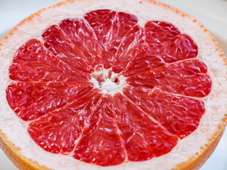 Half of a pink grapefruit on the plate.