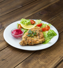 Homemade Breaded Schnitzel with salad and berry sauce
