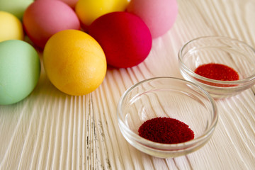 Colored painted eggs and color pigments. Celebrating Easter