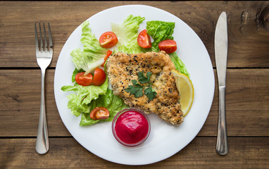 served Homemade Breaded Schnitzel with salad and berry sauce