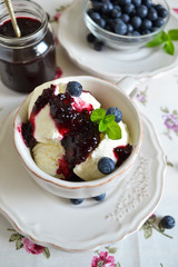 Vanilla ice cream with blueberry jam in a cup