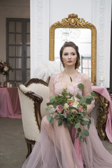 bride's morning. Young girl posing in pink sheer nightie