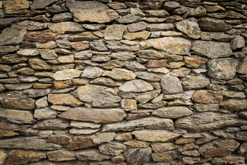 Dry masonry rock wall of natural stones with nice vignetting