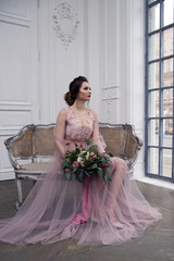 bride's morning. Young girl posing in pink sheer nightie