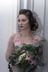 bride's morning. Young girl posing in pink sheer nightie