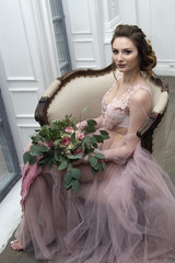 bride's morning. Young girl posing in pink sheer nightie