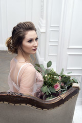 bride's morning. Young girl posing in pink sheer nightie