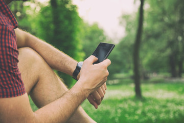 Man using cellphone outdoors.