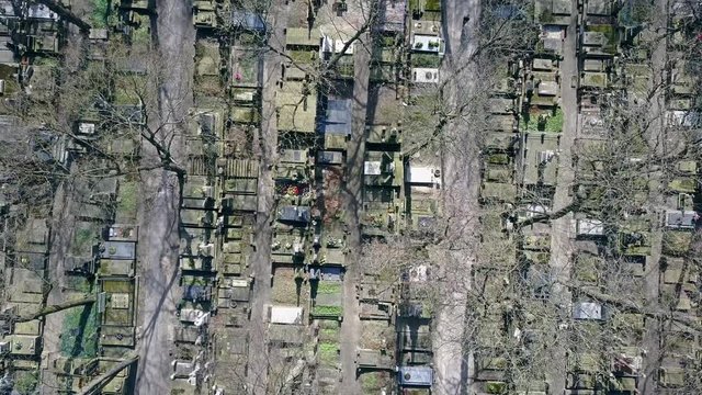 Aerial shot of old cemetery on a sunny spring day, top view. 4K clip
