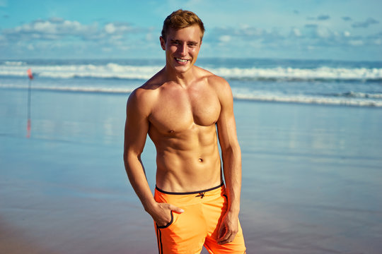 Strong and handsome. Portrait of young caucasian man on the sea beach.