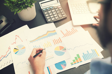 business analysis - man working with financial data charts at office