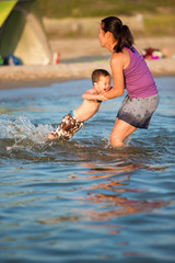 Fototapeta premium Daughter and son playing at the beach