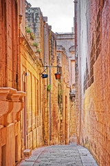 Fototapeta na wymiar Tight Street with lantern in ancient city of Mdina