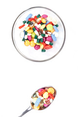 Many colorful pills isolated on white background