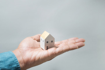 House on human hands.Savings money,building construction,architecture,real estate and property concept