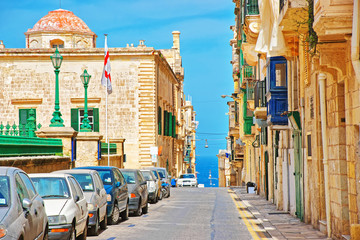 Valletta street view with dome of ancient church