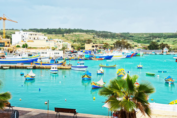 Luzzu colorful boats at Marsaxlokk Harbor in Malta