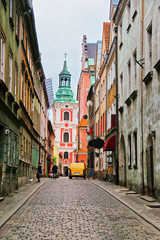 Fototapeta na wymiar Cobblestone Street and St Stanislaus Church in Old town Poznan