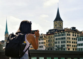 Girl taking photo at Limmatquai in Zurich