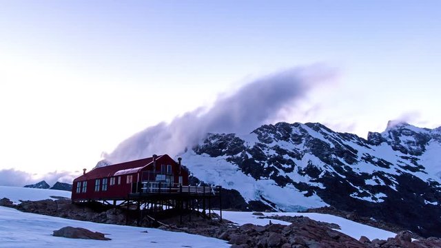 time lapse of clouds in motion above Mueller Hut at the top of a snowy mountain of mount cook national park in the south island of new zealand