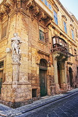 Sculpture of Saint at corner of street in Valletta