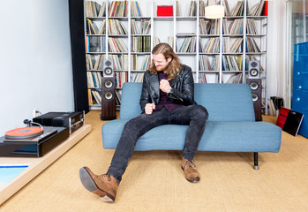 long haired man intensely ejoying rock music