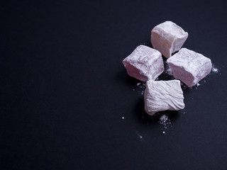 Turkish delight (lokom) isolated on black background