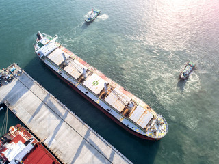 ship on un-berthing the wharf terminal to sailing departure from the port in aerial view