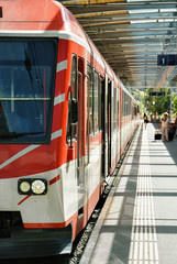 Fototapeta premium Concourse and passengers at Railway train station in Zermatt Switzerland