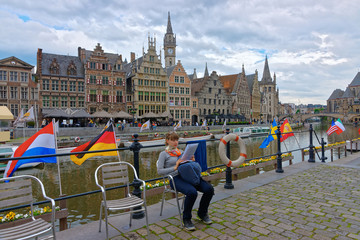 Girl on Embankment on Korenlei and Graslei Canal in Gent © Roman Babakin